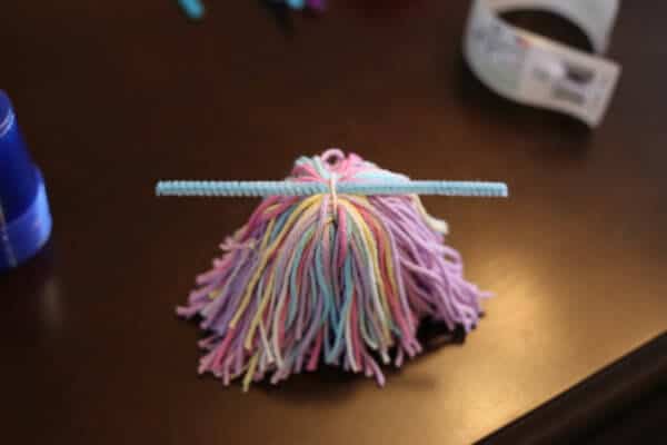 yarn covering a plastic cup for a valentine's day love bug craft