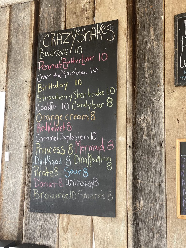 a chalkboard menu listing numerous crazy shake flavors at Terry's Grocery and Pizza in Lynchburg, Ohio